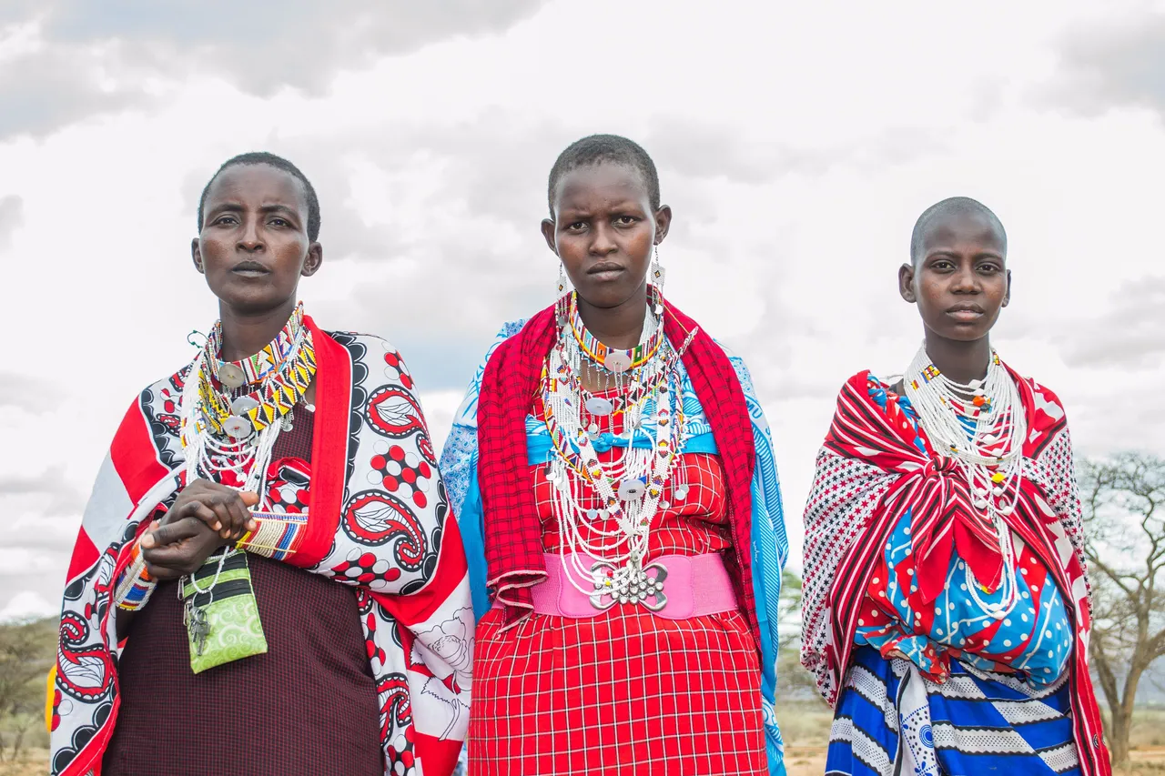 Three Maasai women wearing their own beadwork
