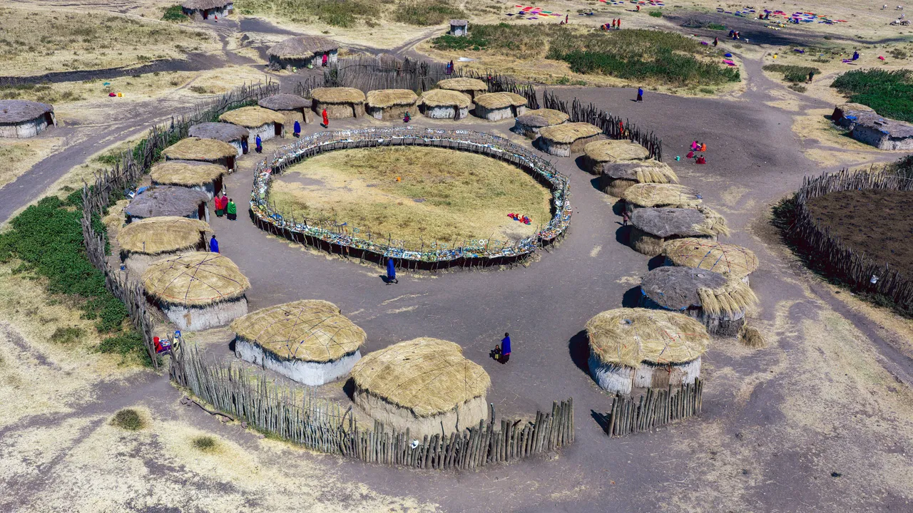 A Maasai homestead seen from above, houses ringing a central livestock enclosure